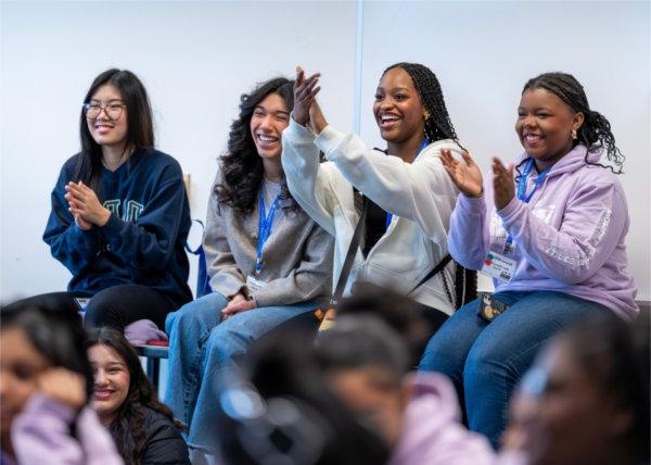 four girls seated at front of room